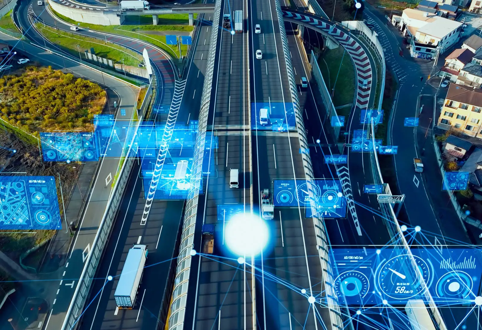 An overhead view of a highway and ramp system with blue futuristic graphics and data charts overlaid on top.